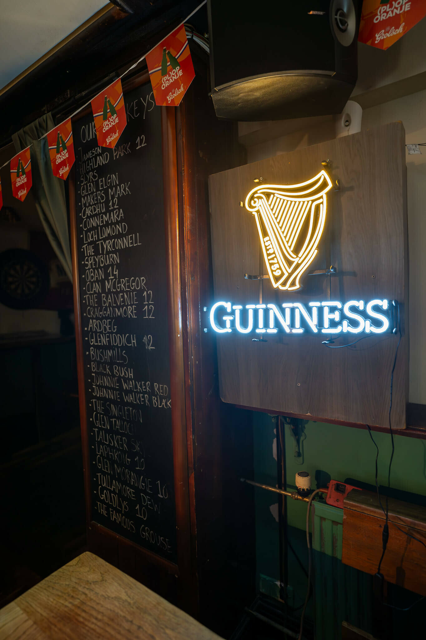 _dsc1907-enhanced-nr.jpg A chalkboard lists a variety of whiskey options on the left side, while a glowing blue and yellow